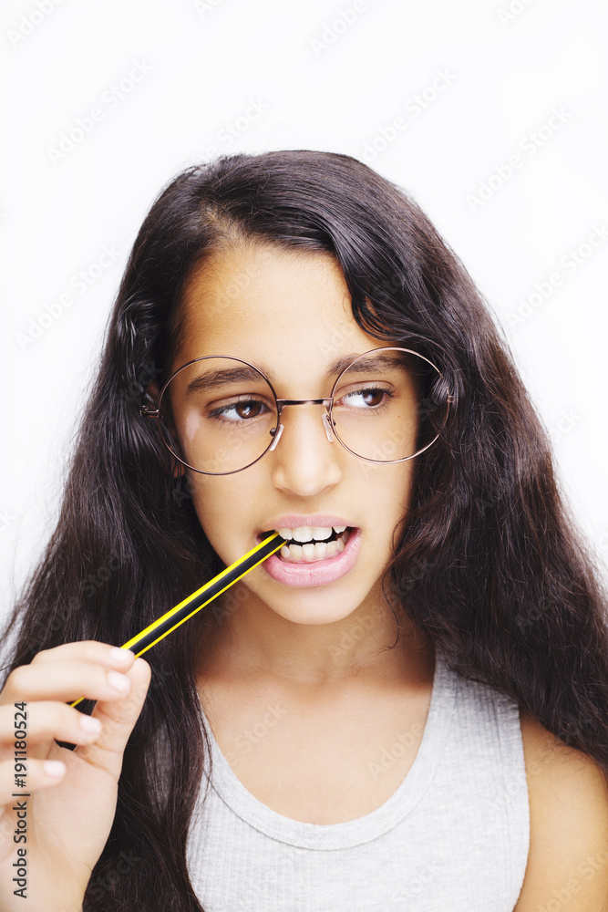 A beautiful African kid girl in glasses holding pencil in hand A beautiful African kid girl in glasses holding pencil in hand