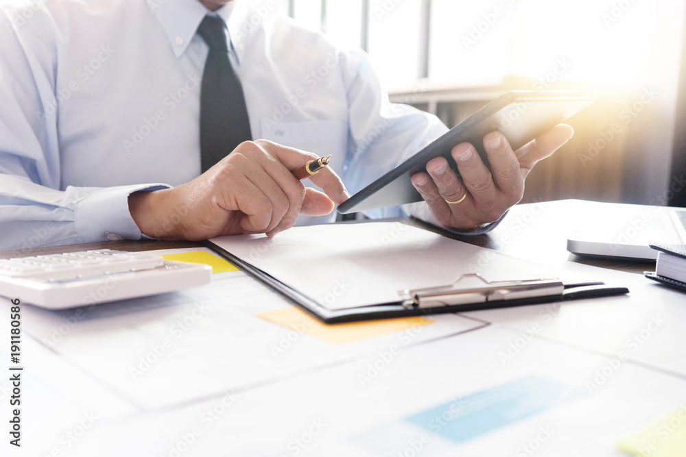 Businessman work with computer on table in office work with paper graph chart Businessman work with computer on table in office work with paper graph chart