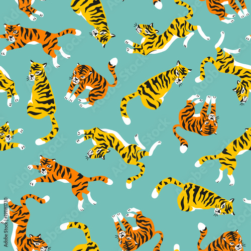 Vector seamless pattern with tigers isolated on the blue background. Animal background for fabric or wallpaper design.