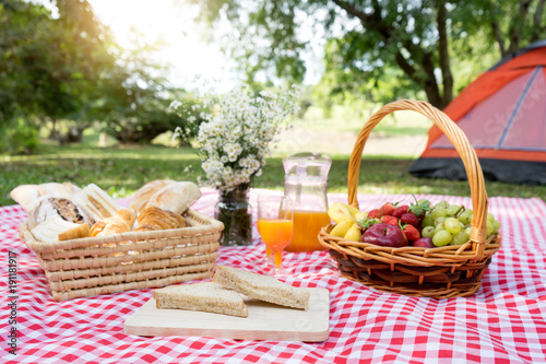 picnic bread crossiant basket with fruit on  red white cloth
