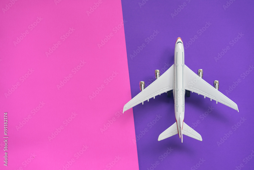 Flat lay design of travel concept with plane on violet and pink background with copy space. Flat lay design of travel concept with plane on violet and pink background with copy space.