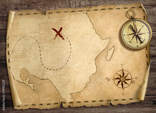 Old treasure pirates' map with compass on wood table. 3d illustration.