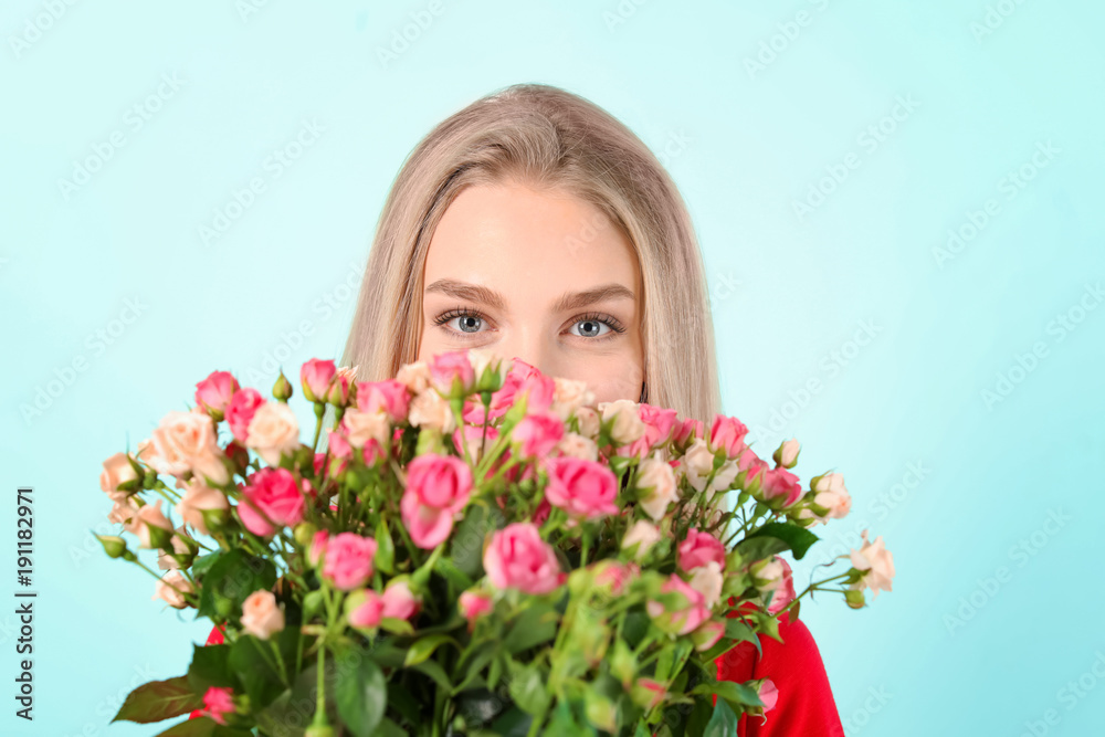 Beautiful young woman with bouquet of roses on color background Beautiful young woman with bouquet of roses on color background