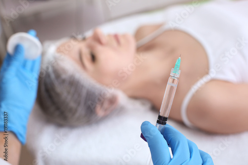 Cosmetologist with syringe in salon  closeup. Biorevitalization procedure