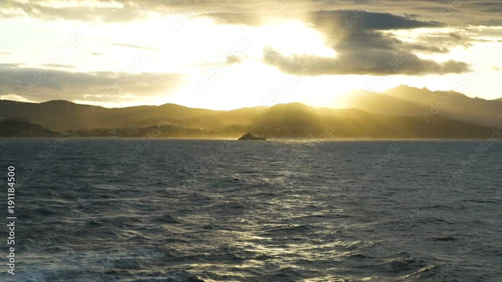 Beautiful view on an island on sunset from a ferryboat, slow motion Beautiful view on an island on sunset from a ferryboat, slow motion