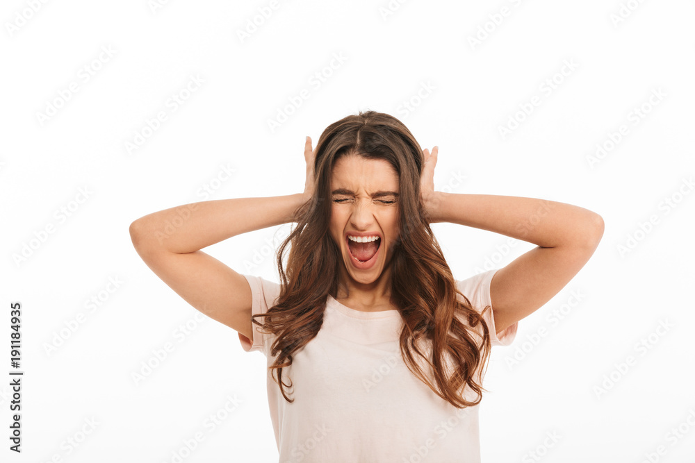 Angry brunette woman in t-shirt screaming with closed eyes Angry brunette woman in t-shirt screaming with closed eyes