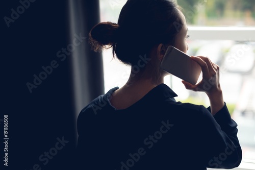 Rear view of woman talking on mobile phone