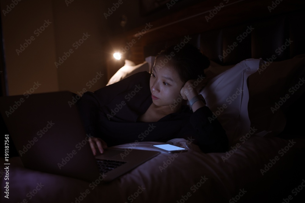 Beautiful woman using laptop on bed Beautiful woman using laptop on bed