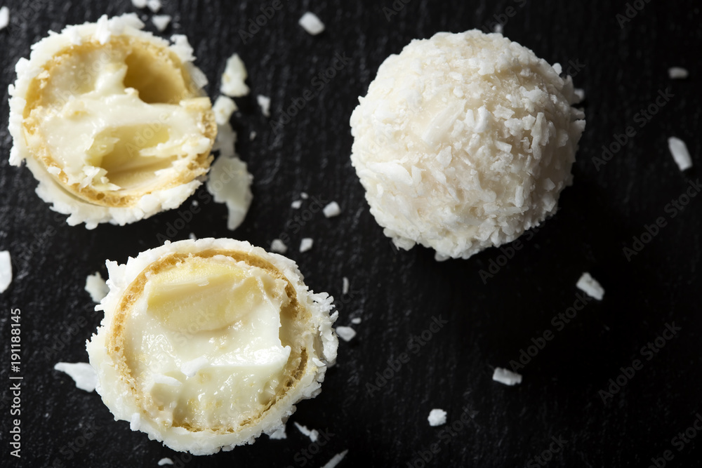 Close up of broken Raffaello white candy with white cream Close up of broken Raffaello white candy with white cream