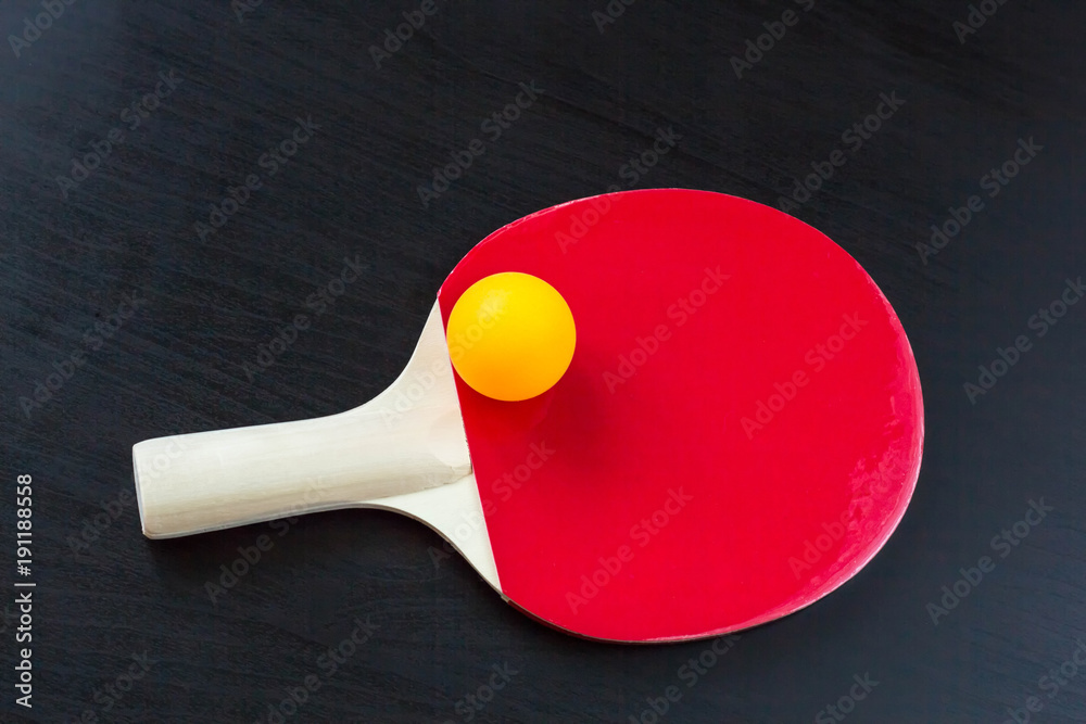 table tennis or ping pong racket and ball on a black background table tennis or ping pong racket and ball on a black background