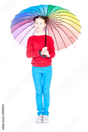 Portrait of cute Asian girl standing under open multicolored umbrella on white background