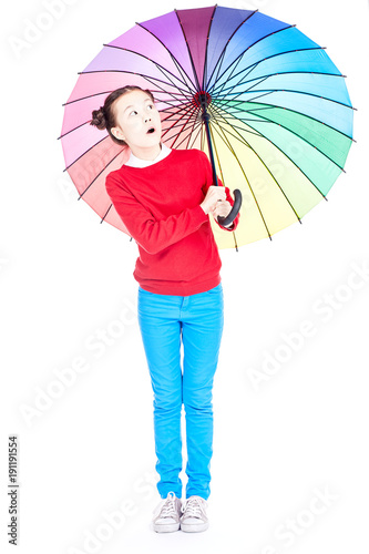 Portrait of cute Asian girl standing under open multicolored umbrella on white background