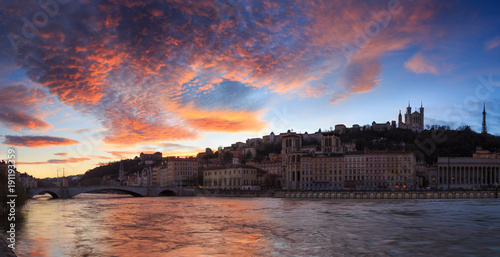 High water levels in the Saone river during a colorful dusk at Quai des Celestins. Lyon, France. photo