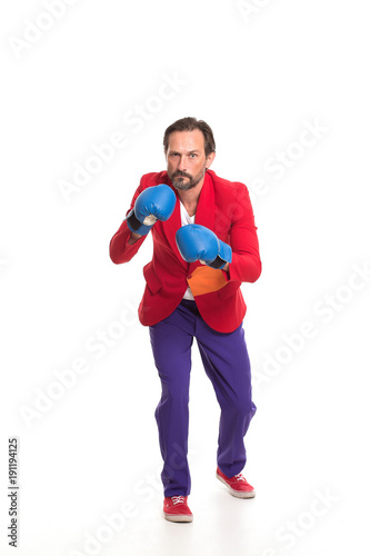 Full length portrait of a boxing man in blue gloves. isolated on white background.