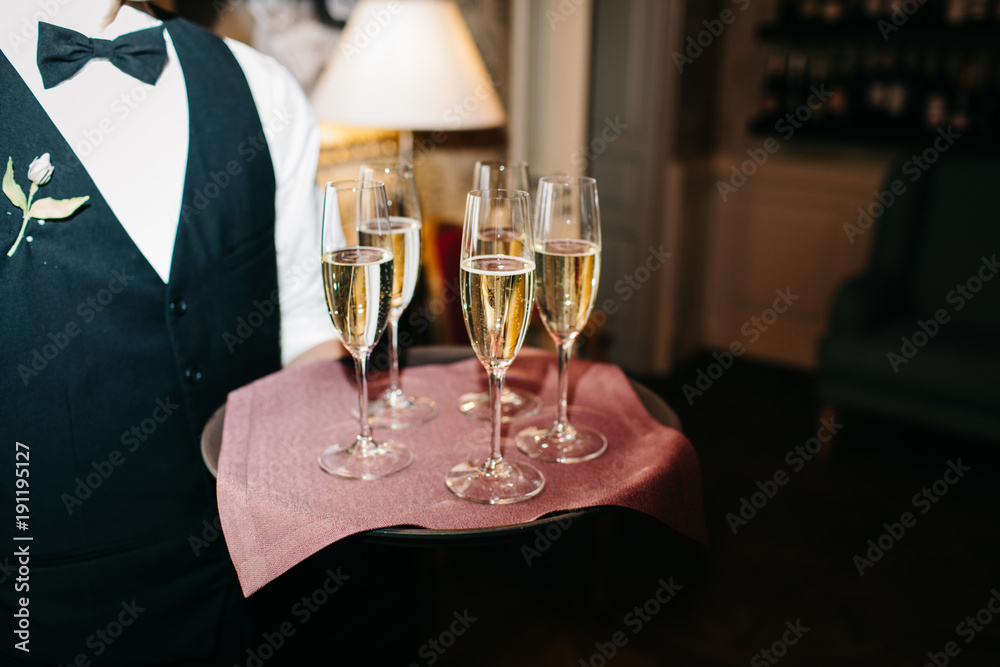 waiter brings glasses of champagne waiter brings glasses of champagne