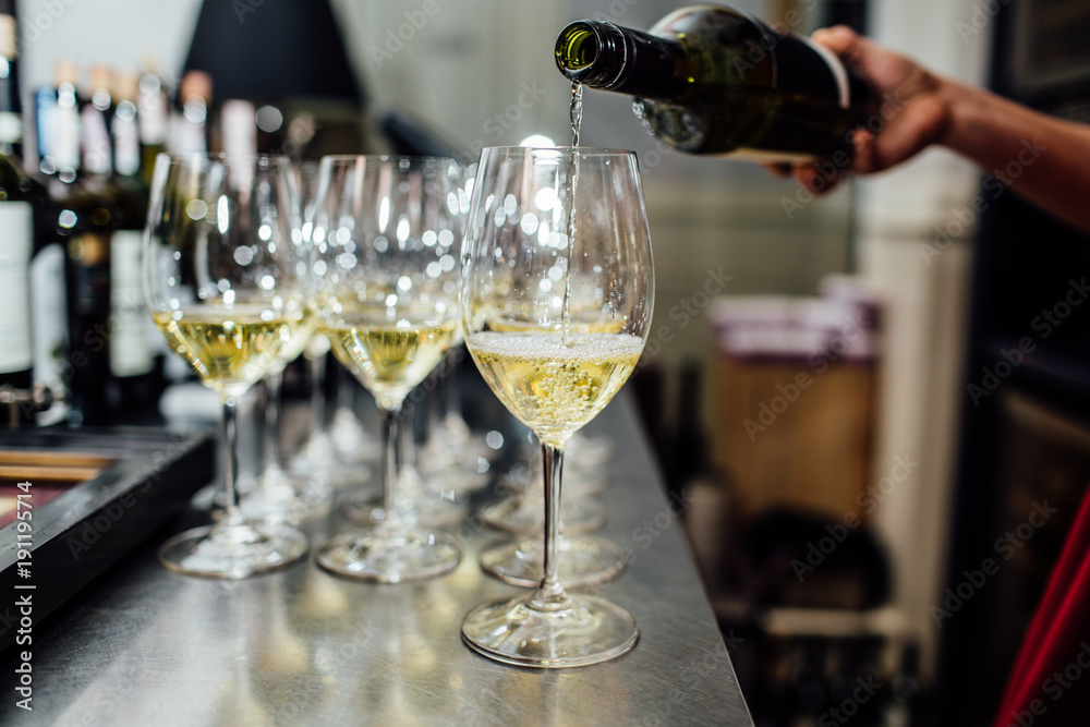 waiter brings glasses of champagne