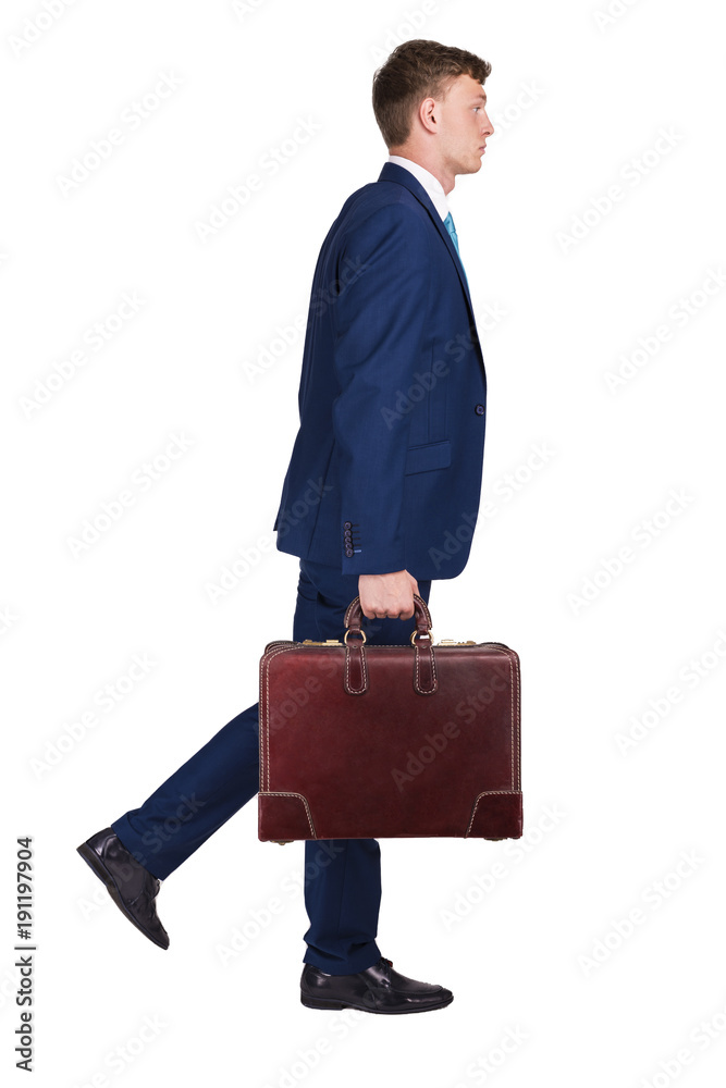 Businessman in fine suit holding in one hand suitcase, walking to the right side. Businessman in fine suit holding in one hand suitcase, walking to the right side.