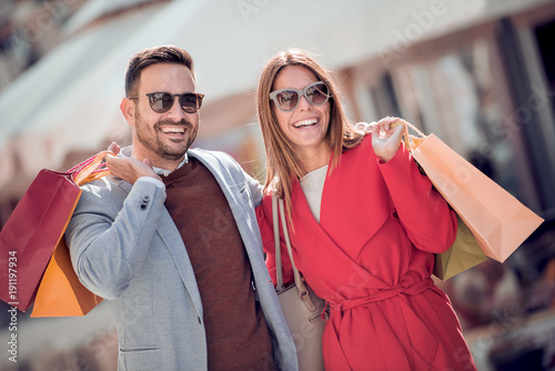 Happy couple shopping together in the city.