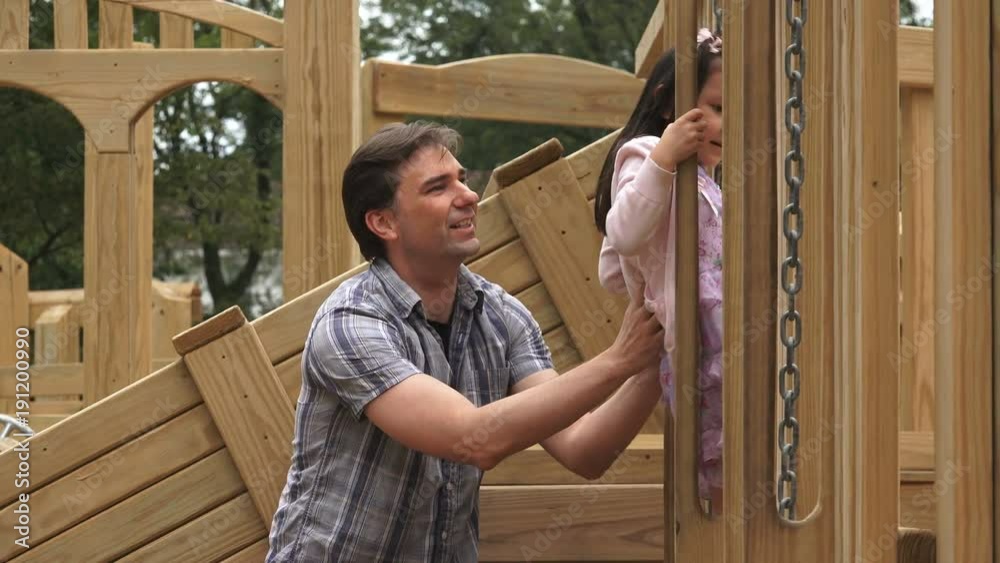 A dad with his daughter at the playground A dad with his daughter at the playground
