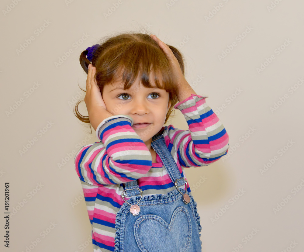 The little girl holds hands the head The little girl holds hands the head