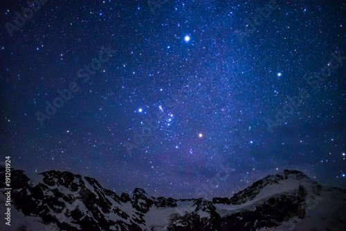 amazing starry sky above the summit of snowy mountains in a national park in the south island of New Zealand