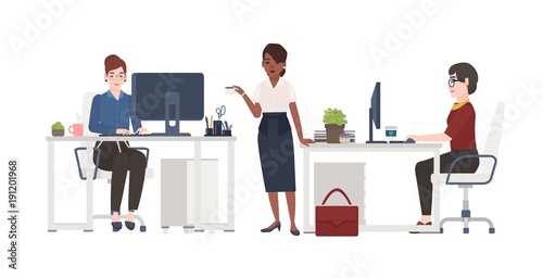Women working at office. Female clerks dressed in smart clothes sitting in ch...