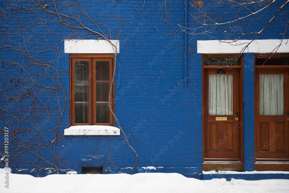 Blue house facade in the Plateau Mont-Royal neighborhood in Montreal during winter