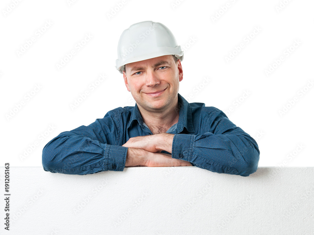 a man in a construction helmet holds a big white poster a man in a construction helmet holds a big white poster
