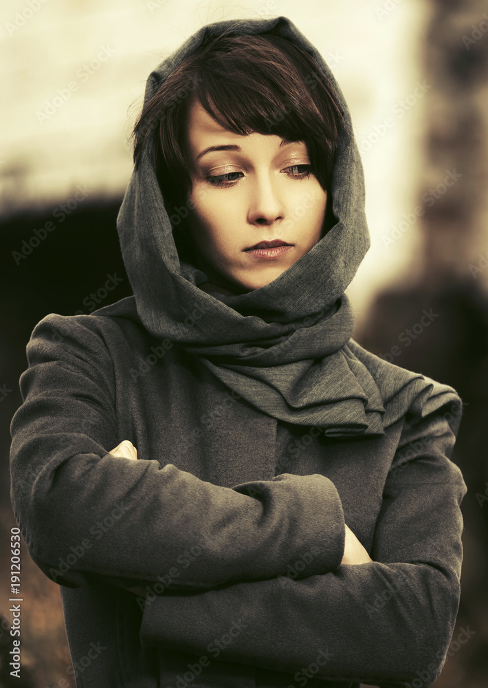 Sad young fashion woman in classic coat and headscarf walking outdoor Sad young fashion woman in classic coat and headscarf walking outdoor
