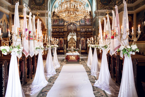 Interior of church with decoration for wedding with candels light