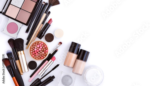 Makeup brush and decorative cosmetics on a white background with empty space. Top view