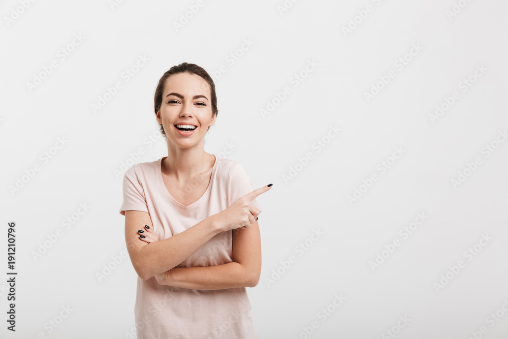 smiling girl pointing on something isolated on white smiling girl pointing on something isolated on white