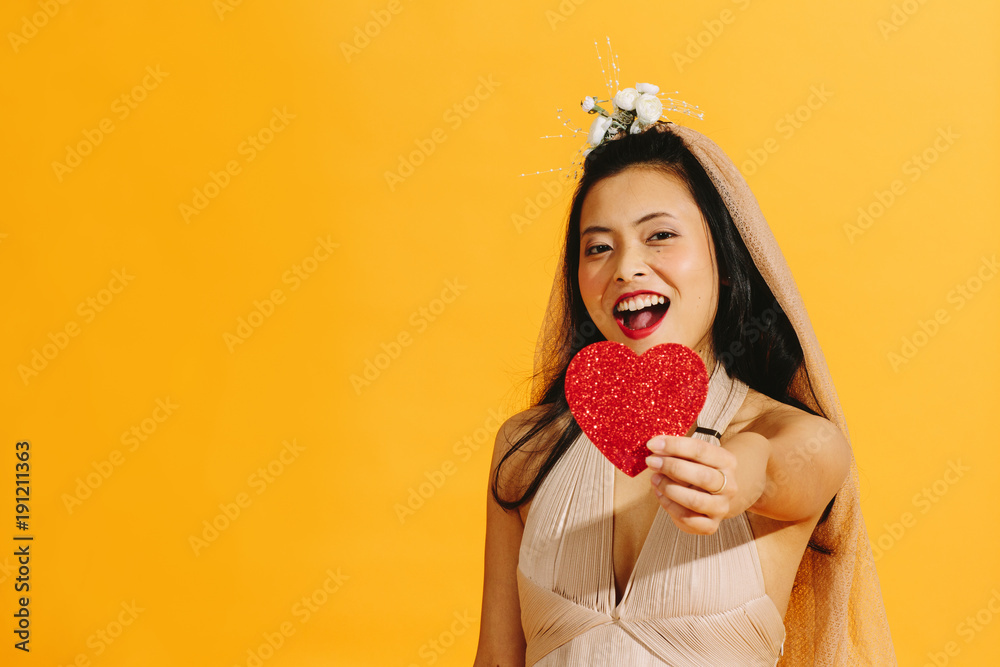 Laughing asian bride giving red heart to camera Laughing asian bride giving red heart to camera