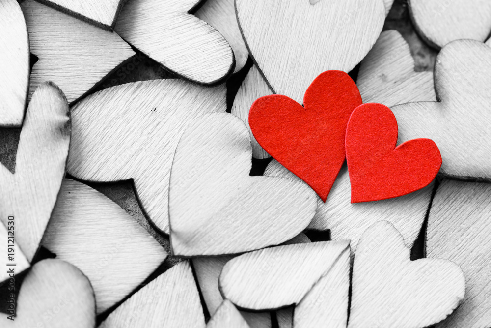 Obraz premium Vintage style of 2 red hearts with wooden hearts on a wooden background. Happy Valentine's Day concept.