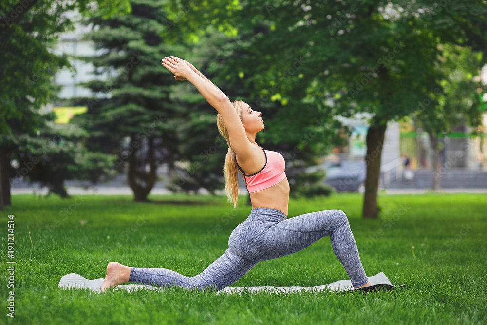 Woman making asana exercises outdoors Woman making asana exercises outdoors