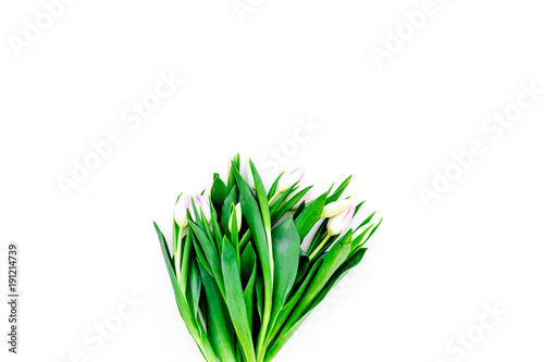 Spring bouquet of delicate pink tulips on white background top view copy space