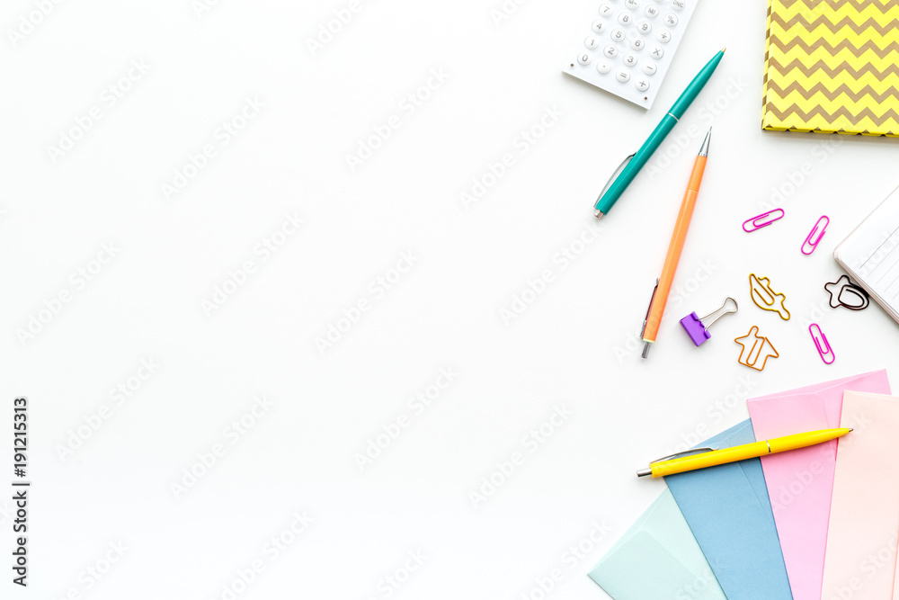 Scattered stationery on student's desk. White background top view copy space Scattered stationery on student's desk. White background top view copy space