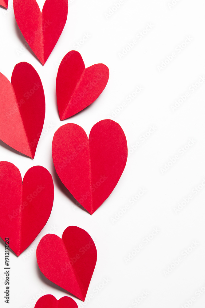 Red handmade paper hearts on a white background
