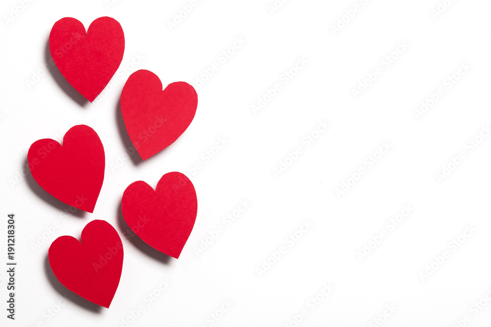 Red handmade paper hearts on a white background