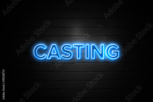 Casting neon Sign on brickwall photo