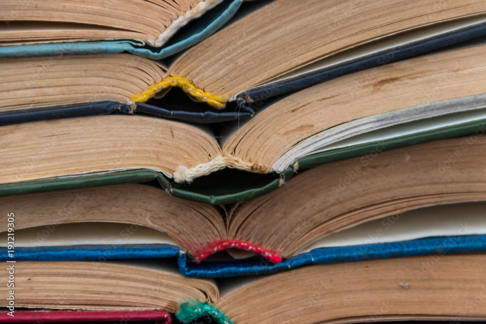 Fototapeta premium Stack of the old open books for background