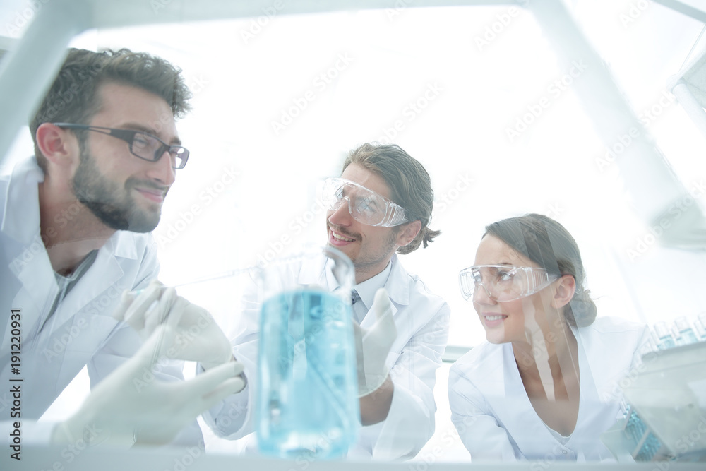 Group of scientists working on an experiment at the laboratory Group of scientists working on an experiment at the laboratory