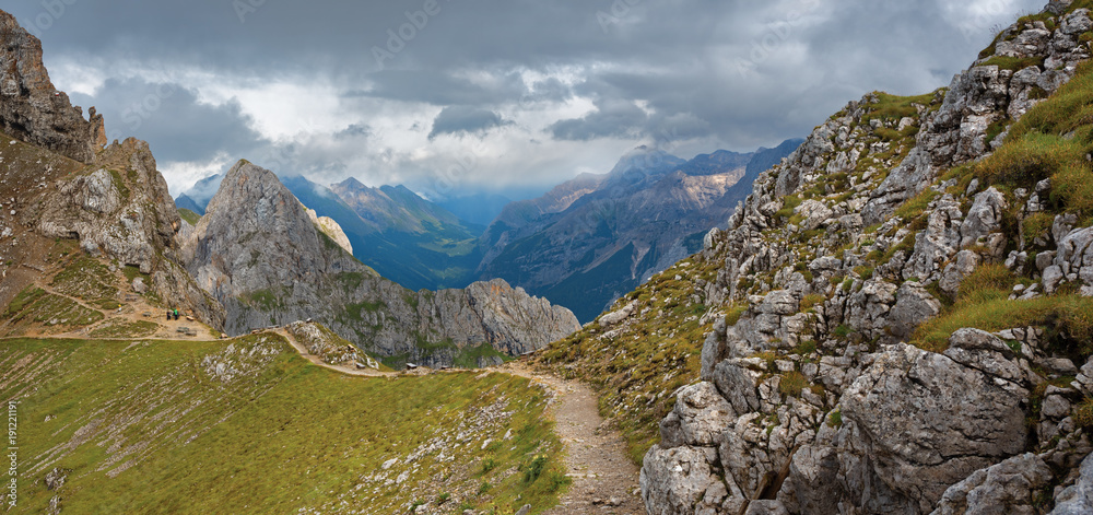 Trail among rocks with distant mountain tops view