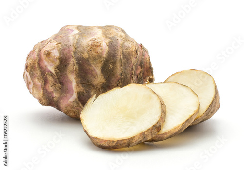 One Jerusalem artichoke tuber with three round slices isolated on white background sweet crisp topinambur set. photo