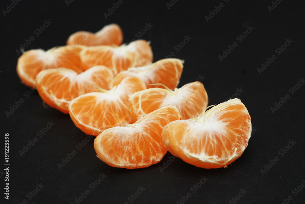 Tangerines, Peeled tangerine and Tangerine Slices on Black background Isolated. Tangerines, Peeled tangerine and Tangerine Slices on Black background Isolated.