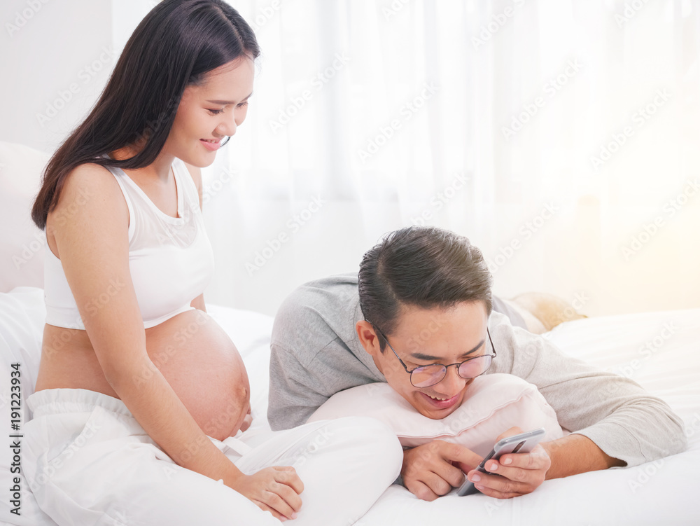 Happy pregnant woman and her husband waiting for baby, happy family love and care. Happy pregnant woman and her husband waiting for baby, happy family love and care.