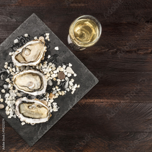 Overhead photo of oysters with wine and copy space