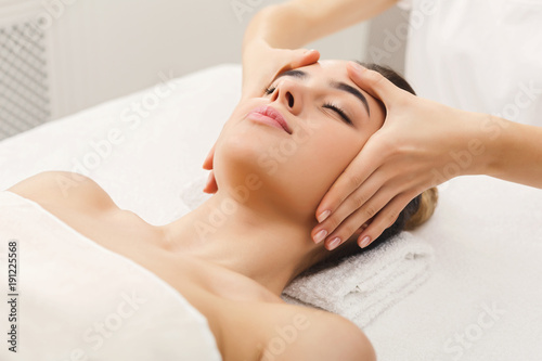 Woman getting professional facial massage at spa salon