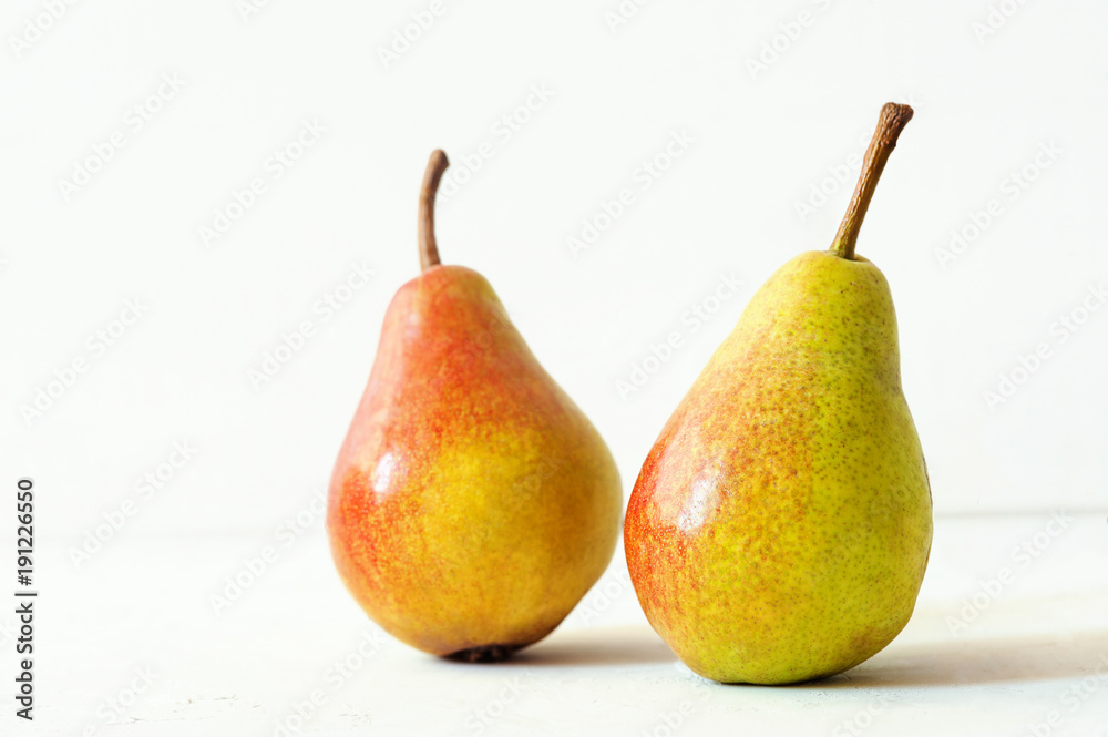 Two ripe red yellow pear fruits on white background Two ripe red yellow pear fruits on white background