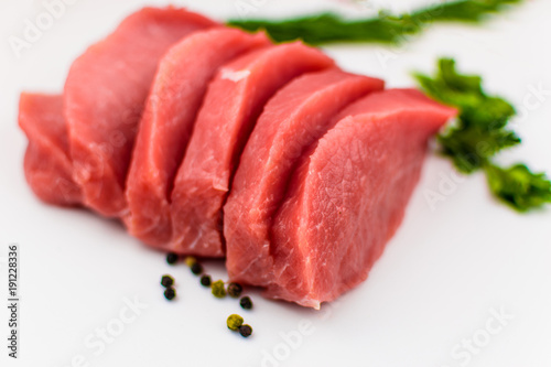 Pork fillet chopped on a white background.